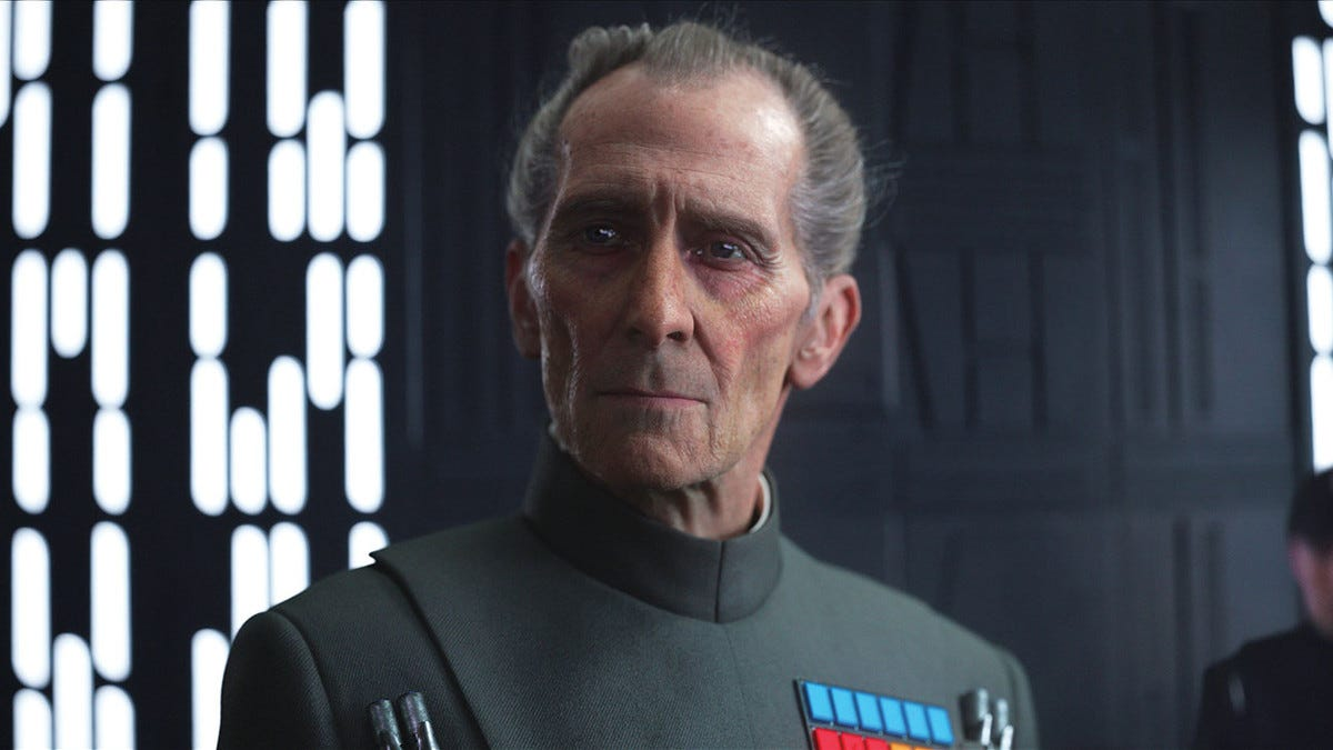 A shot from Rogue One, in which a CGI version of Peter Cushing dressed as an officer of the Empire stares blankly.